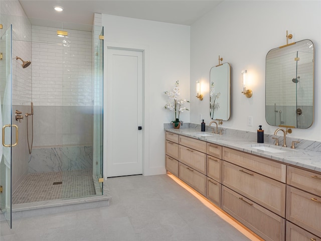 bathroom featuring double vanity, a stall shower, a sink, and recessed lighting