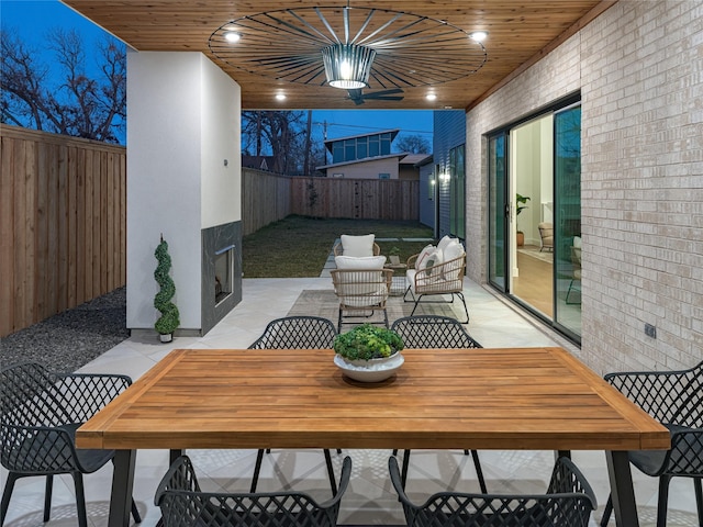 view of patio / terrace with outdoor dining area, a fenced backyard, and ceiling fan