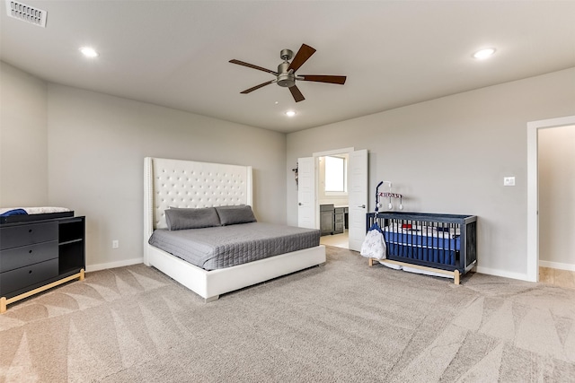 carpeted bedroom featuring ceiling fan, recessed lighting, visible vents, and baseboards