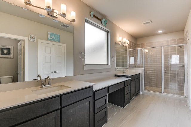 full bath featuring a stall shower, visible vents, and vanity