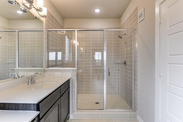 full bath with a shower stall and vanity