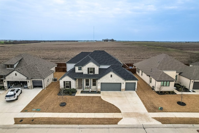 view of front of home featuring a garage, a shingled roof, and concrete driveway