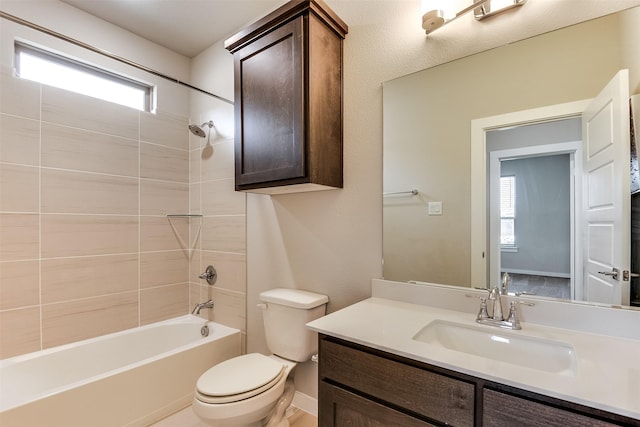 bathroom with toilet, vanity, baseboards, and shower / bathtub combination