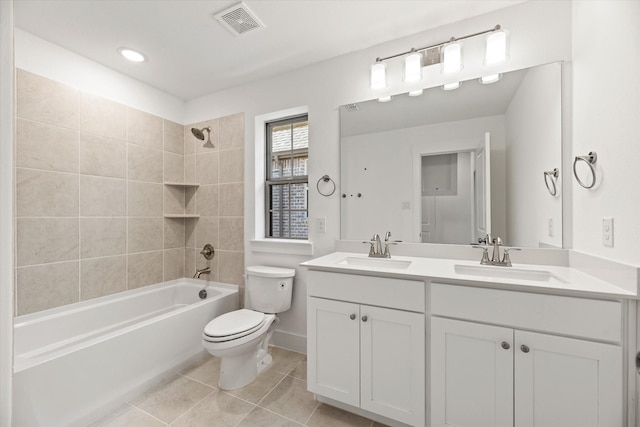 full bath featuring toilet, visible vents, a sink, and tile patterned floors