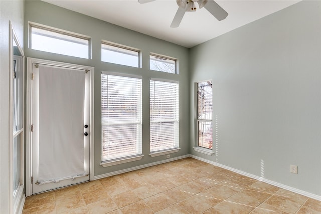 interior space featuring ceiling fan and baseboards