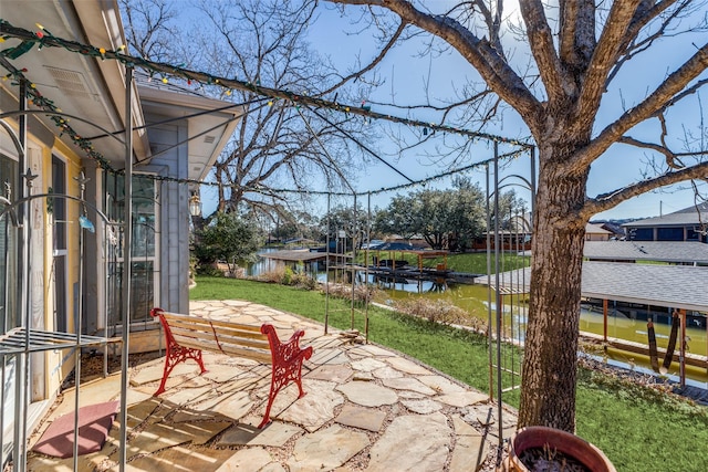 view of patio / terrace with a dock and a water view