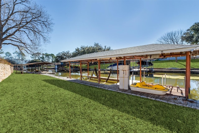 dock area featuring a water view, boat lift, and a lawn