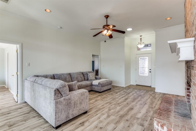 living room featuring light wood-type flooring, a ceiling fan, and recessed lighting