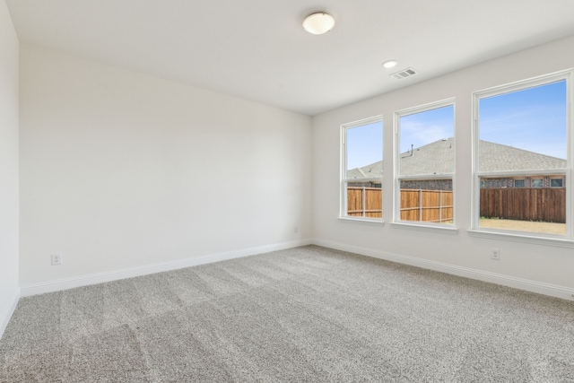spare room with recessed lighting, visible vents, carpet flooring, and baseboards