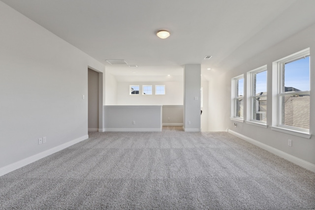 interior space featuring carpet floors, visible vents, and baseboards