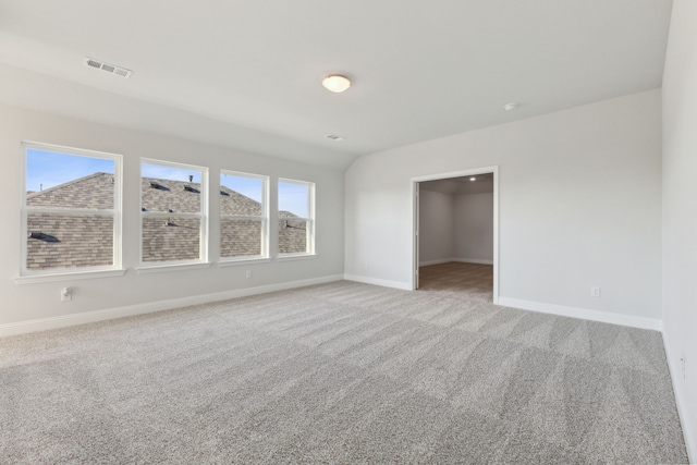 unfurnished room with light colored carpet, visible vents, and baseboards