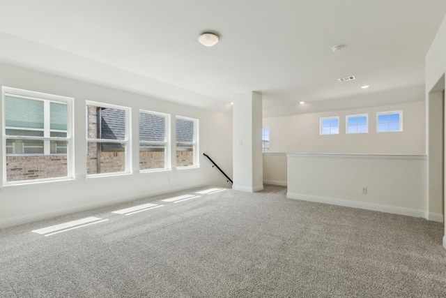empty room with visible vents, recessed lighting, baseboards, and carpet floors