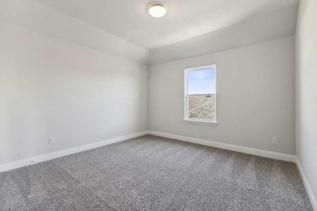 carpeted empty room with baseboards