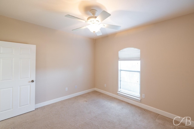 empty room with carpet, baseboards, and ceiling fan