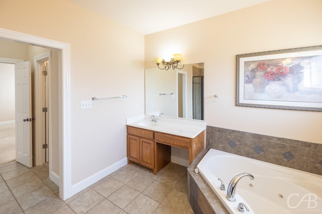 full bath with a chandelier, baseboards, vanity, and a tub with jets