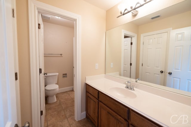 bathroom with visible vents, vanity, tile patterned flooring, and toilet