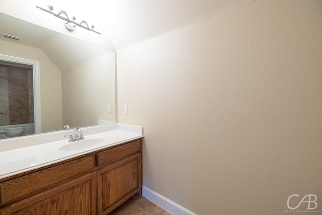 bathroom with visible vents, toilet, tile patterned floors, vaulted ceiling, and vanity