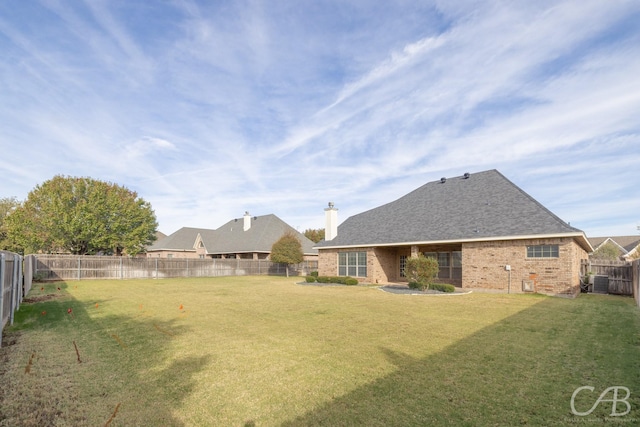 view of yard with central air condition unit and a fenced backyard