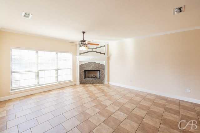 unfurnished living room featuring ceiling fan, visible vents, ornamental molding, and a fireplace