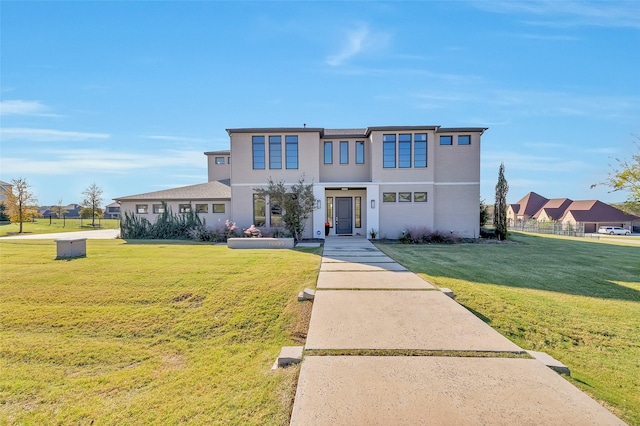 view of front facade with a front yard and stucco siding