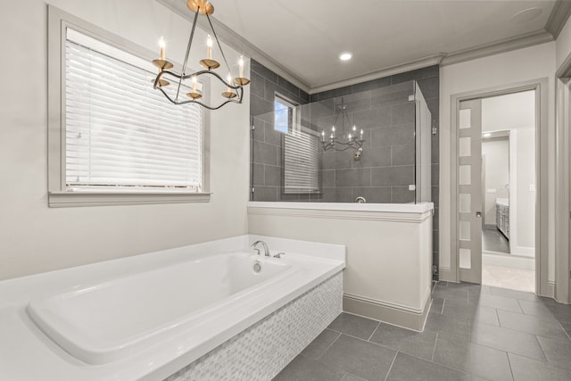 bathroom with tile patterned floors, a garden tub, a notable chandelier, and tiled shower