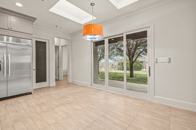 kitchen featuring a skylight, baseboards, hanging light fixtures, gray cabinets, and stainless steel built in refrigerator