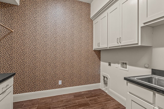 laundry room featuring washer hookup, baseboards, cabinet space, wood tiled floor, and electric dryer hookup