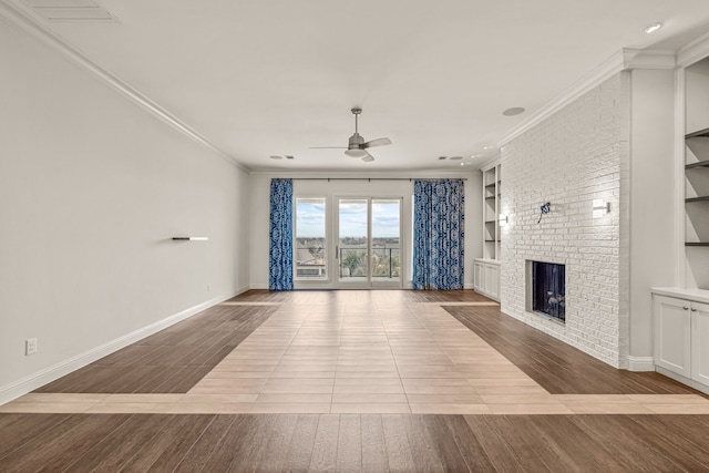 unfurnished living room with built in features, a fireplace, ornamental molding, and wood finished floors