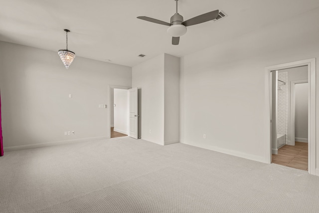 spare room with carpet, visible vents, ceiling fan, and baseboards