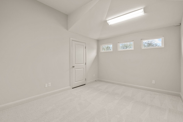 empty room with baseboards and light colored carpet