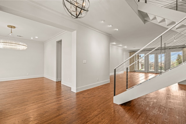 interior space with stairway, crown molding, a chandelier, and wood finished floors