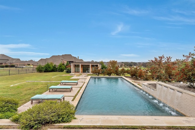 view of pool with fence, a fenced in pool, and a yard