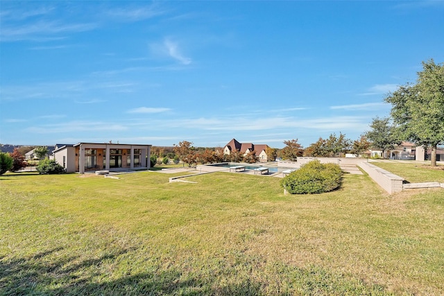 view of yard with a patio and an outdoor pool