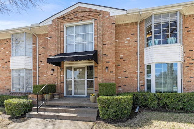 exterior space featuring brick siding