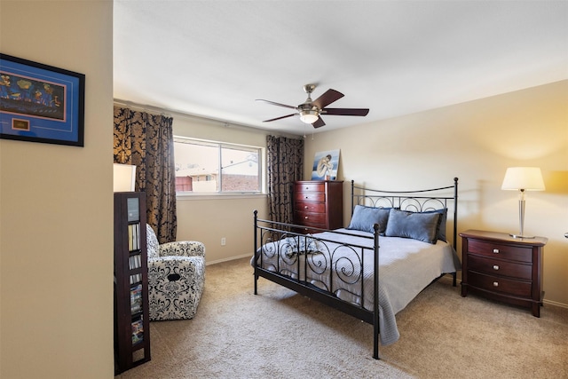 carpeted bedroom with ceiling fan and baseboards