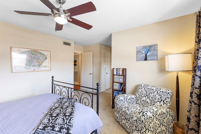 bedroom with light carpet, visible vents, and a ceiling fan