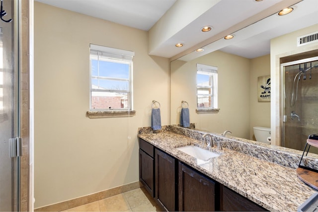 full bath featuring visible vents, toilet, a shower stall, baseboards, and tile patterned floors