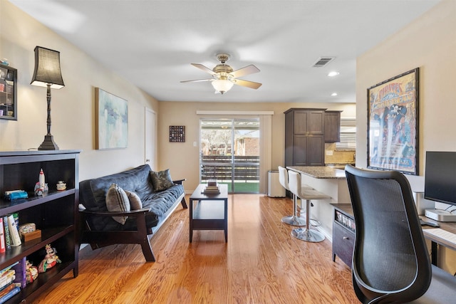 office area featuring light wood-style flooring, visible vents, a ceiling fan, and recessed lighting