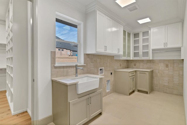 laundry area featuring cabinet space, light tile patterned floors, a sink, washer hookup, and electric dryer hookup