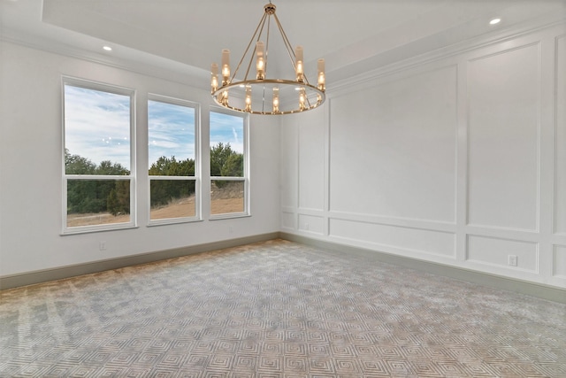 carpeted empty room with baseboards, a chandelier, a decorative wall, and recessed lighting