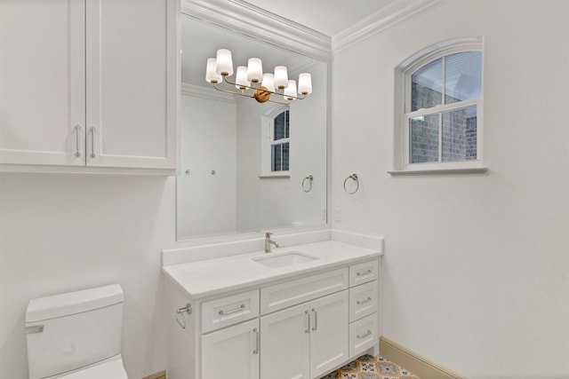 bathroom featuring baseboards, vanity, toilet, and crown molding