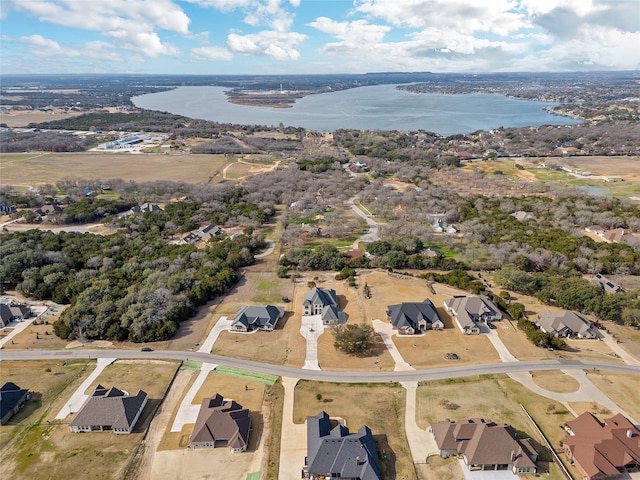 birds eye view of property with a water view and a residential view