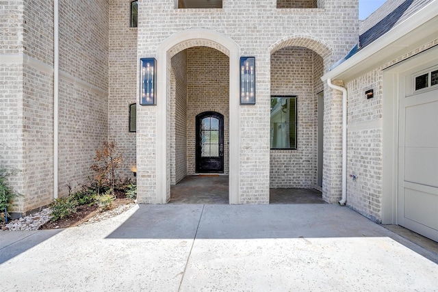 doorway to property with brick siding