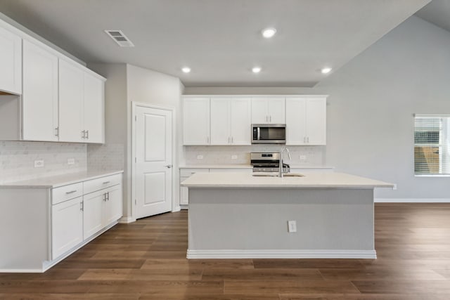 kitchen with visible vents, appliances with stainless steel finishes, dark wood finished floors, and a sink