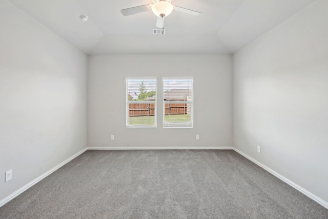 empty room featuring visible vents, baseboards, lofted ceiling, ceiling fan, and carpet