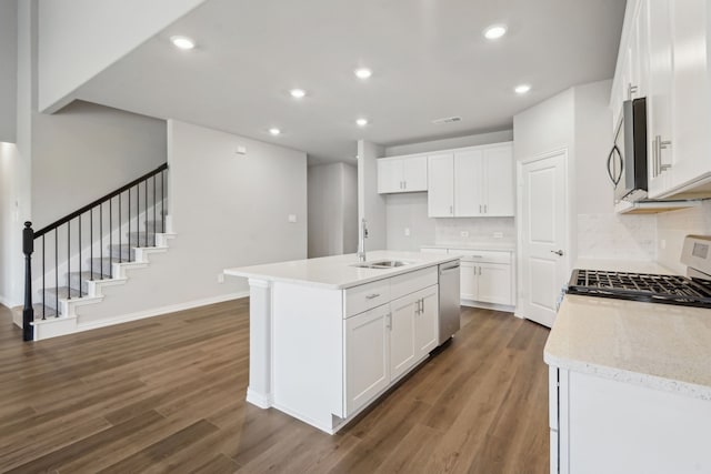 kitchen featuring appliances with stainless steel finishes, dark wood-style flooring, a sink, and recessed lighting