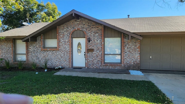 view of front facade featuring board and batten siding, brick siding, a front lawn, and roof with shingles