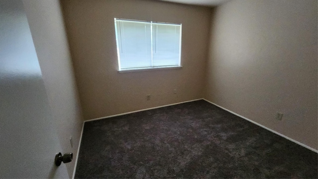437 W Grenoble Dr, Grand Prairie, TX 75052 - spare room with dark colored carpet and baseboards