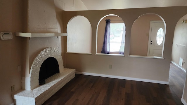 437 W Grenoble Dr, Grand Prairie, TX 75052 - unfurnished living room with visible vents, a fireplace, baseboards, and wood finished floors