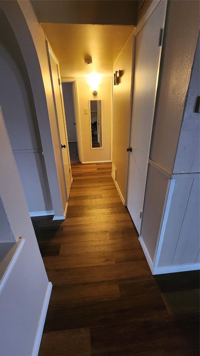 437 W Grenoble Dr, Grand Prairie, TX 75052 - corridor with baseboards, visible vents, arched walkways, and dark wood-style flooring